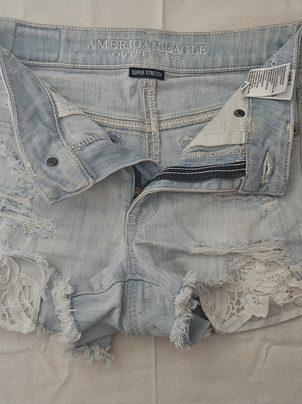 American Eagle Outfitters Light Wash Denim Shorts with Lace Trim